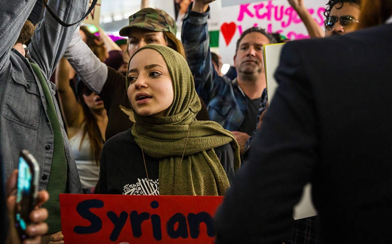 A young woman protests the Muslim travel ban at Los Angeles International Airport on Jan. 29, 2017. (Courtesy of Dustin Pea)