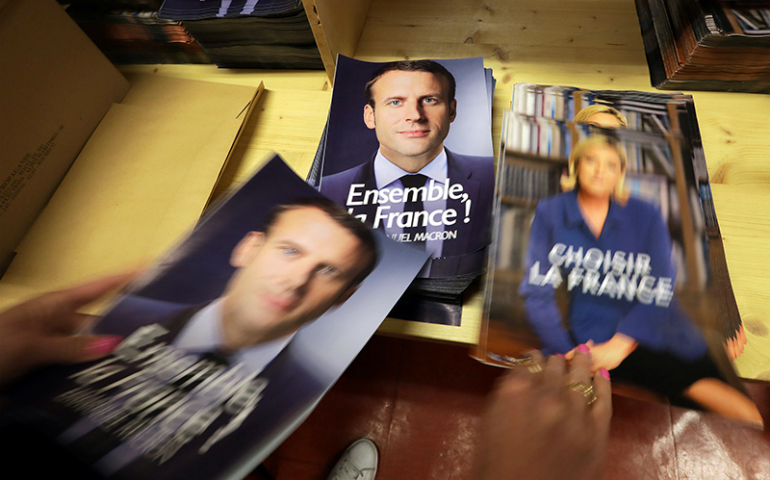 A civil servant prepares electoral documents for the May 7 second round of the French presidential election between Emmanuel Macron, left, and Marine Le Pen, in Nice, France, on May 3, 2017. (Reuters/Eric Gaillard)
