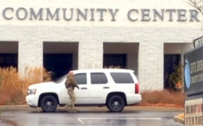 An officer responds to a bomb threat at the Levite Jewish Community Center in Birmingham, Ala. (Screenshot from video)