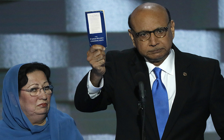 Khizr Khan, right, with wife Ghazala Khan, whose son Humayun S. M. Khan died serving in the U.S. Army, offers to loan his copy of the Constitution to Republican U.S. presidential nominee Donald Trump during the last night of the Democratic National Convention in Philadelphia, PA, on July 28, 2016. (Reuters/Mike Segar)