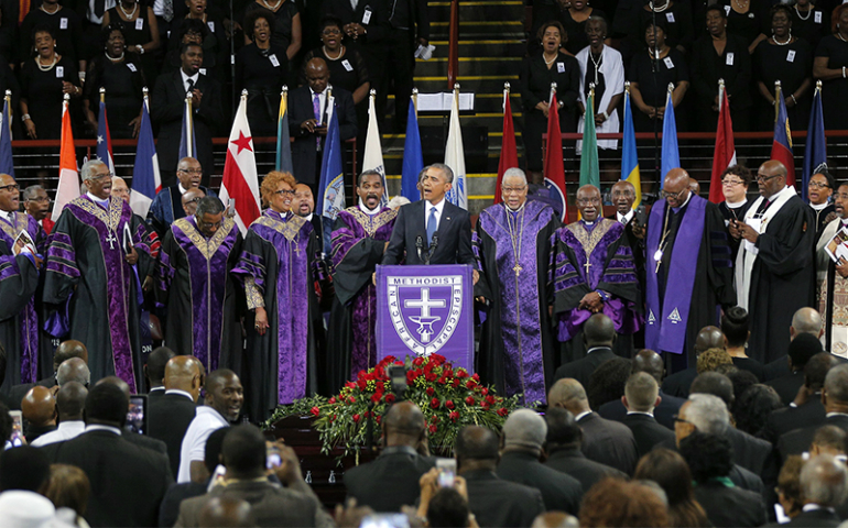 U.S. President Barack Obama leads mourners in singing the song "Amazing Grace" as he delivers a eulogy in honor of the Rev. Clementa Pinckney during funeral services for Pinckney in Charleston, S.C., on June 26, 2015. Pinckney is one of nine victims of a mass shooting at the Emanuel African Methodist Episcopal Church. (Reuters/Brian Snyder)