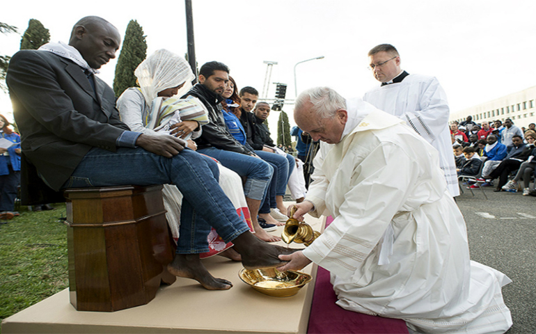 Pope Francis washes the foot of a refugee during the foot-washing ritual at the Castelnuovo di Porto refugees center near Rome on March 24, 2016. Pope Francis washed and kissed the feet of refugees, including three Muslim men. (Reuters/Osservatore Romano)