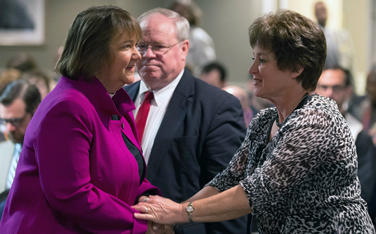 Bishop Karen Oliveto, left, greets Dixie Brewster ahead of the opening of oral arguments before the United Methodist Judicial Council meeting on April 25, 2017, in Newark, N.J. At rear is the Rev. Keith Boyette, representing Brewster before the council. (UMNS/Mike DuBose)