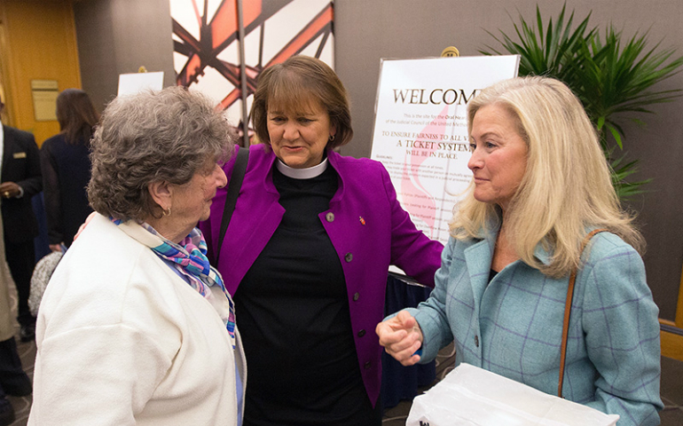 Bishop Karen Oliveto, center, visits with her mother, Nelle Oliveto, left, and her wife, Robin Ridenour, outside the meeting of the United Methodist Judicial Council meeting on April 25, 2017, in Newark, N.J. (UMNS/Mike DuBose)