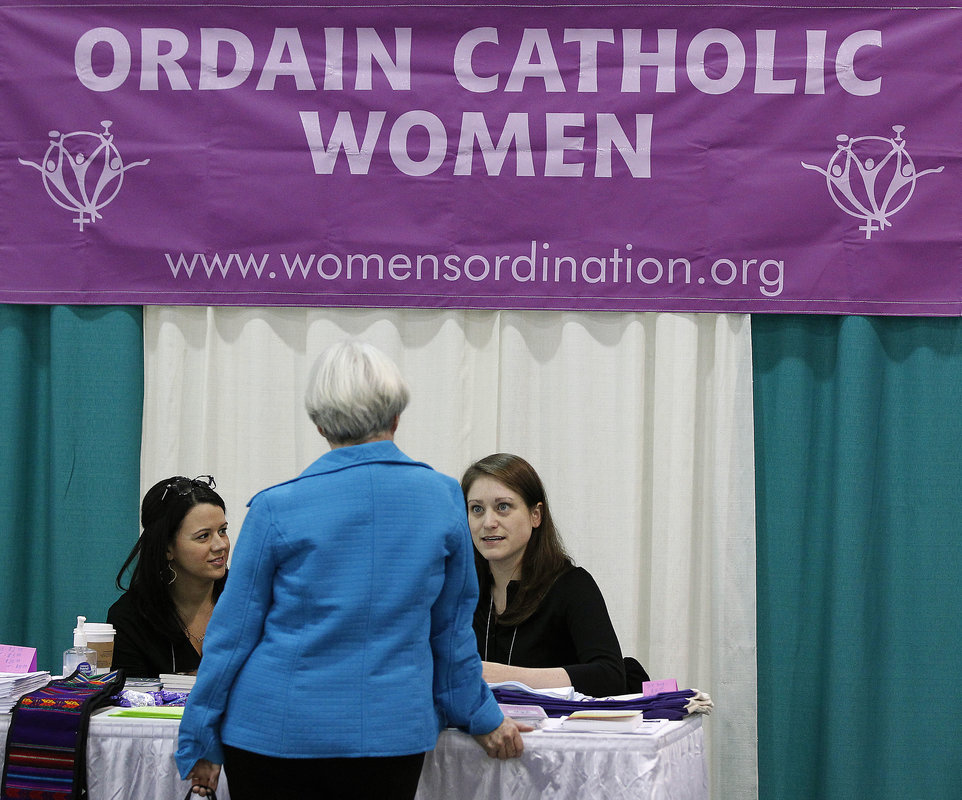 Erin Saiz Hanna (left) and Kate McElwee with the Women's Ordination Conference talk with attendees at Call to Action's 2013 national conference.