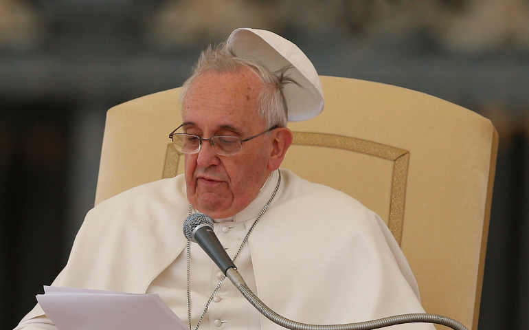 Pope Francis loses his zucchetto to a gust of wind during a general audience in St. Peter's Square Feb. 19, 2014. (CNS/Paul Haring)