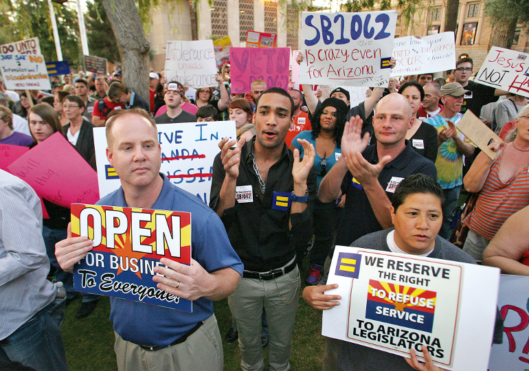 Gay rights supporters call on Gov. Jan Brewer to veto Senate Bill 1062 at the Arizona State Capitol in Phoenix Feb. 24. (Newscom/ZUMA Press/Deirdre Hamill)