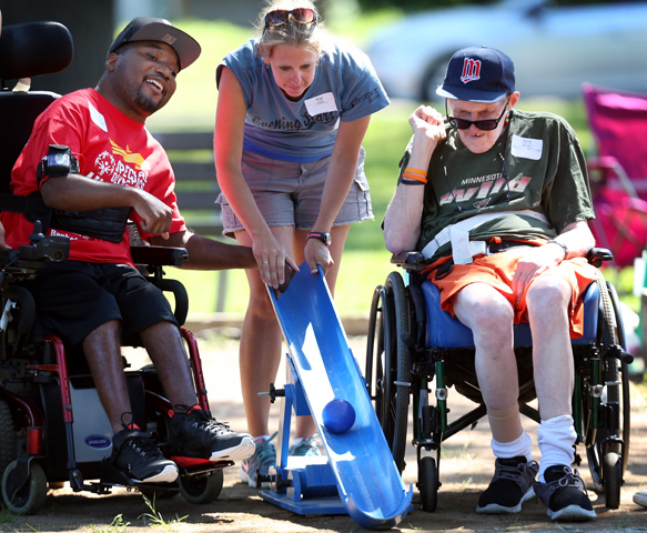 Winslo Riley, left, with his coach, Amy Jones, competes with David Gustavson during a Special Olympics Minnesota bocce ball competition at Beltrami Park July 19, 2015, in Minneapolis. (Newscom/ZUMA Press/Jerry Holt)