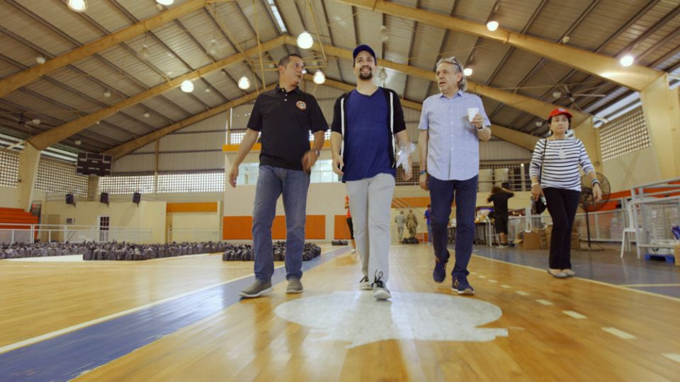 Lin-Manuel Miranda (center) with his father, Luis Miranda (right), and mother, Luz Towns-Miranda (far right), assisting with disaster relief efforts in Puerto Rico (Courtesy of HBO) Lin-Manuel Miranda (center) with his father, Luis Miranda (right), and mother, Luz Towns-Miranda (far right), assisting with disaster relief efforts in Puerto Rico (Courtesy of HBO)