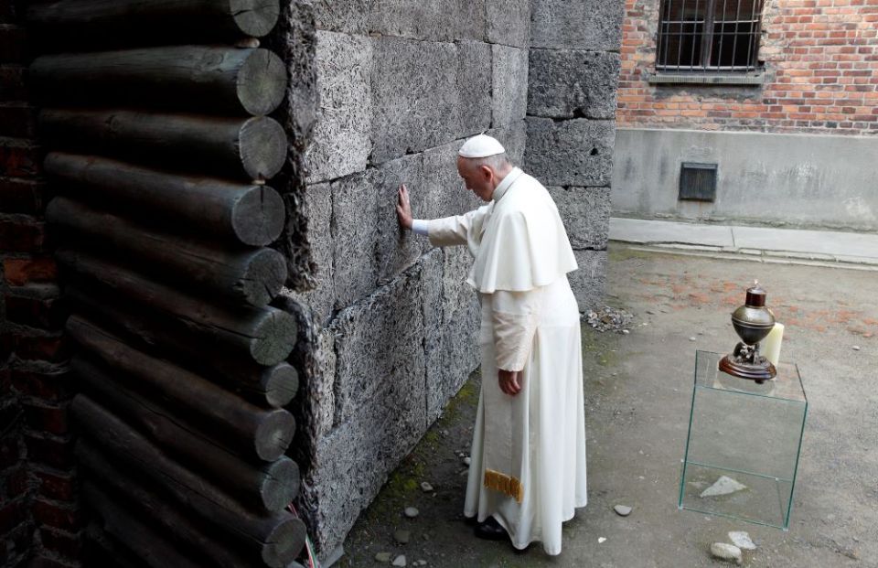 Pope Francis touches the death wall at the Auschwitz Nazi death camp in Oświęcim, Poland, in this July 29, 2016, file photo. (CNS/Paul Haring)