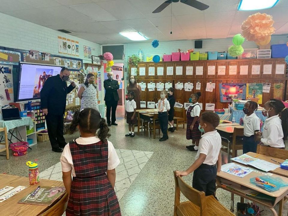 Archbishop Thomas J. Rodi of Mobile, Ala., visits students at Little Flower Catholic School in Mobile in September. Beginning Nov. 8, COVID-19 masks became optional in the district. (CNS/Archdiocese of Mobile/Jennifer Tolbert)