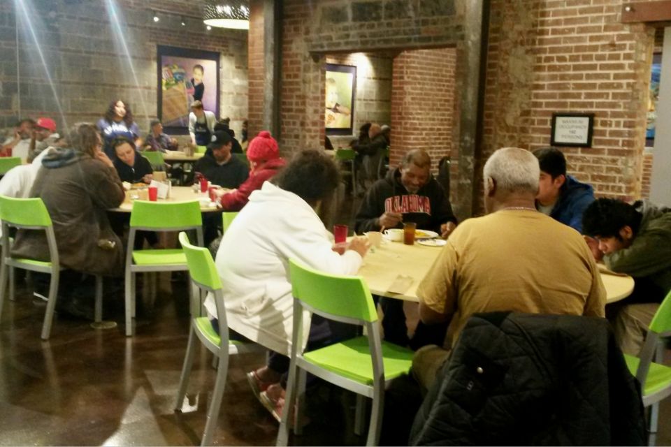 People enjoy dinner at Bishop Sullivan Center's One City Café, a restaurant-style community kitchen offering free meals in Kansas City, Missouri, as volunteers and staff serve them Feb. 26. (NCR photo/Maria Benevento) People enjoy dinner at Bishop Sullivan Center's One City Café, a restaurant-style community kitchen offering free meals in Kansas City, Missouri, as volunteers and staff serve them Feb. 26. (NCR photo/Maria Benevento)