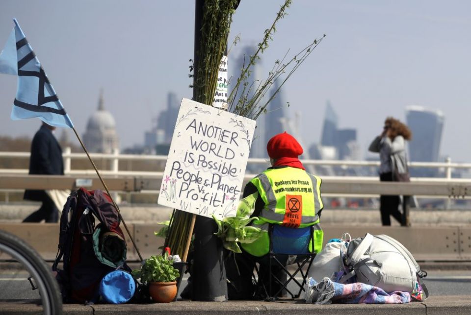 A demonstrator sits in the road during a climate protest organized by the environmental group Extinction Rebellion. The weeklong nationwide protest included this April 15, 2019, action on Waterloo Bridge in London. 