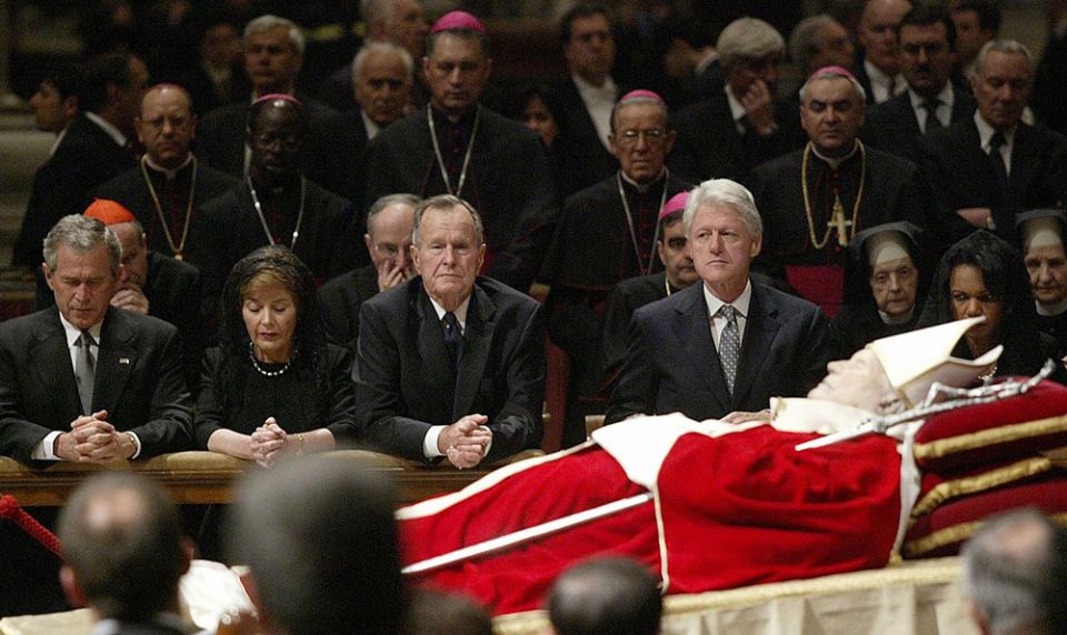 On April 6, 2005, President George W. Bush, first lady Laura Bush and former Presidents George H.W. Bush and Bill Clinton pay respects to Pope John Paul II while viewing the late pontiff's body in St. Peter's Basilica at the Vatican. (CNS/Reuters)