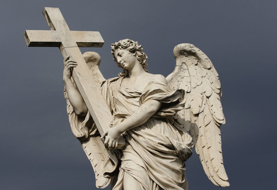 A statue of an angel carrying Christ's cross is seen on the Castel Sant'Angelo bridge in Rome. (CNS/Paul Haring)