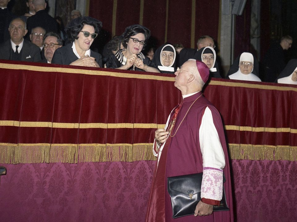 A bishop speaks with two laywomen during a meeting of the Second Vatican Council in St. Peter's Basilica at the Vatican in 1962. (CNS/Catholic Press Photo/Giancarlo Giuliani)