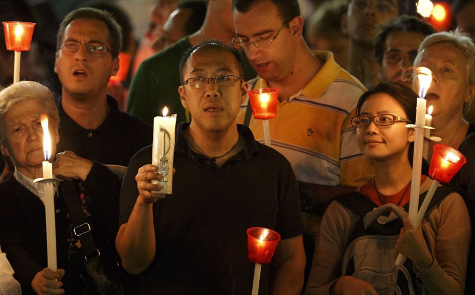 Pilgrims attend a candlelight vigil in St. Peter's Square at the Vatican Oct. 11, 2012, to mark the 50th anniversary of the opening of the Second Vatican Council. (CNS/Paul Haring)