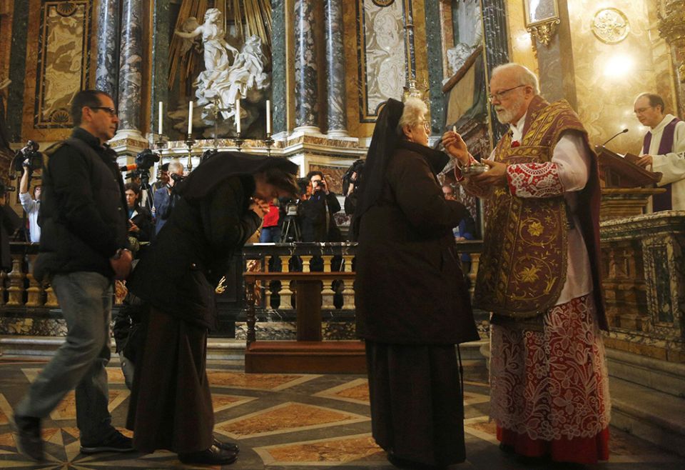 Cardinal Sean O'Malley of Boston gives Communion as he celebrates Mass at his titular church, Santa Maria della Vittoria, March 10, 2013, in Rome. (CNS/Reuters/Chris Helgren) Cardinal Sean O'Malley of Boston gives Communion as he celebrates Mass at his titular church, Santa Maria della Vittoria, March 10, 2013, in Rome. (CNS/Reuters/Chris Helgren)