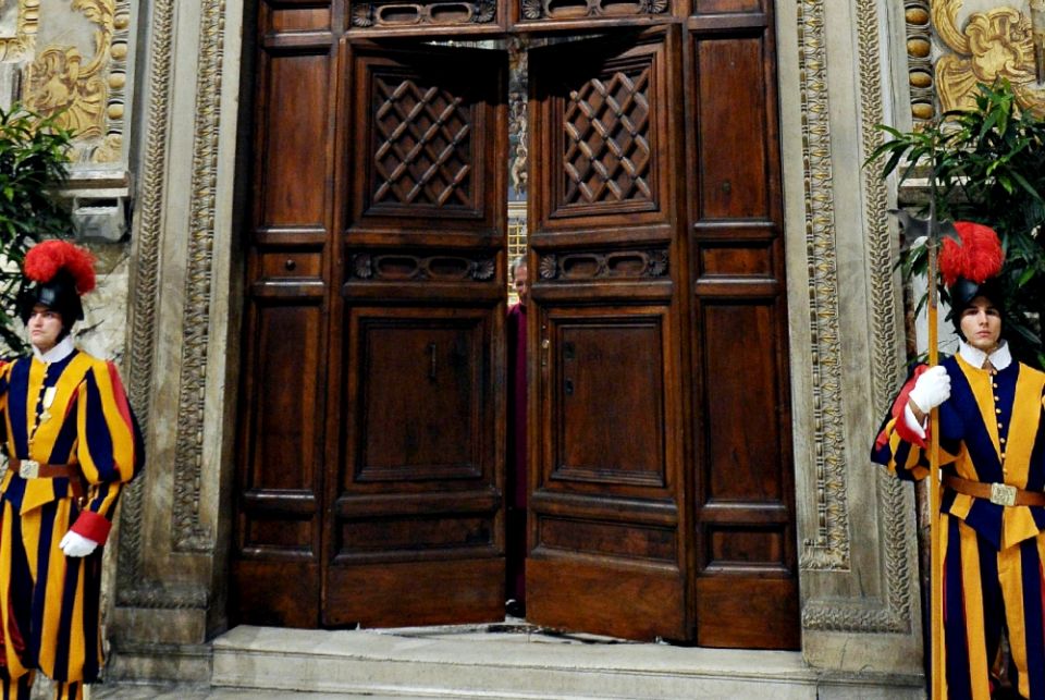 Swiss Guards stand in front of the doors to the Vatican's Sistine Chapel as cardinals begin the conclave to elect a successor to Pope Benedict XVI in March 2013. (CNS/L'Osservatore Romano via Reuters) Swiss Guards stand in front of the doors to the Vatican's Sistine Chapel as cardinals begin the conclave to elect a successor to Pope Benedict XVI in March 2013. (CNS/L'Osservatore Romano via Reuters)