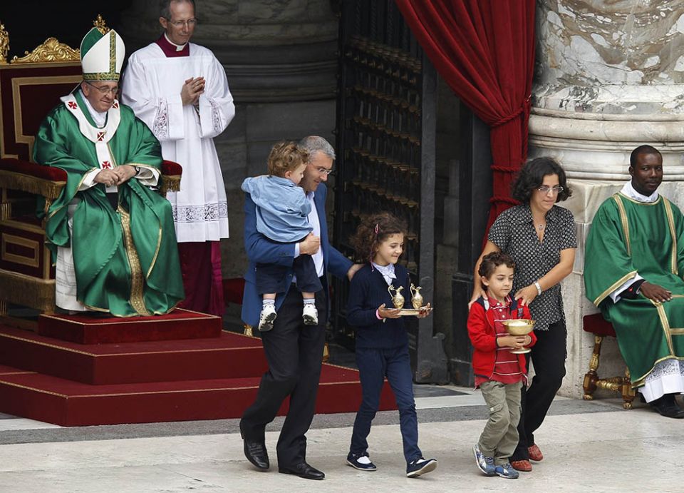 Pope Francis watches as a family carries offertory gifts to the altar during a Mass for catechists in St. Peter's Square at the Vatican in September 2013. (CNS photo/Paul Haring) Pope Francis watches as a family carries offertory gifts to the altar during a Mass for catechists in St. Peter's Square at the Vatican in September 2013. (CNS photo/Paul Haring)