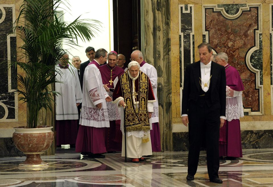 Pope Benedict XVI walks with a cane as he arrives for a meeting of cardinals at which he read his resignation in this Feb. 11, 2013, file photo from the Vatican. There were no media members in attendance. (CNS/L'Osservatore Romano)
