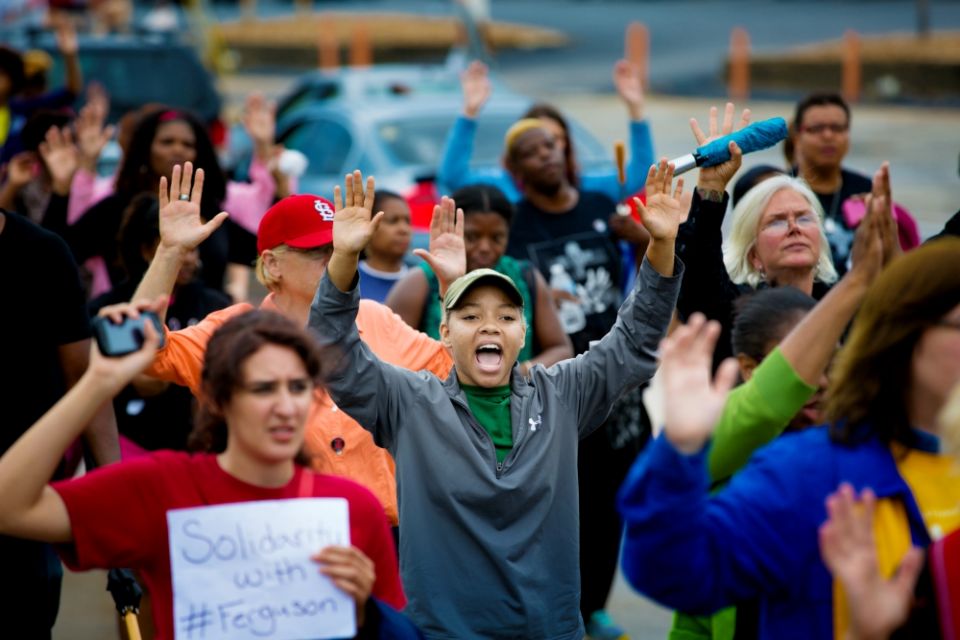 Protesters hold their hands in the air during a demonstration on Aug. 16, 2014, against the shooting death of Michael Brown in Ferguson, Missouri. (CNS/St. Louis Review/Lisa Johnston) Protesters hold their hands in the air during a demonstration on Aug. 16, 2014, against the shooting death of Michael Brown in Ferguson, Missouri. (CNS/St. Louis Review/Lisa Johnston)