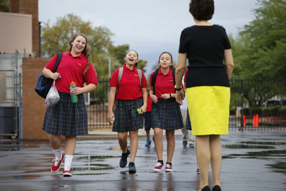 Girls greet a teacher as they arrive for class at St. Jerome Catholic School in Phoenix. More than 1.9 million U.S. students were returning to Catholic elementary, middle and secondary schools this academic year, according to the National Catholic Educati