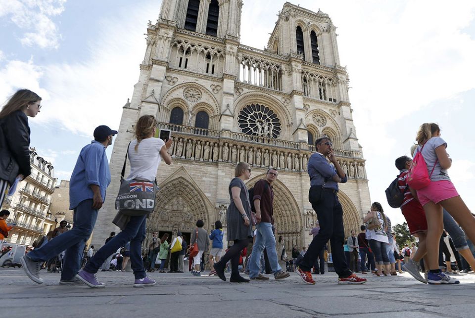 People stand in line outside Notre Dame Cathedral Aug. 22, 2014, in Paris People stand in line outside Notre Dame Cathedral Aug. 22, 2014, in Paris. (CNS/Reuters/Charles Platiau)