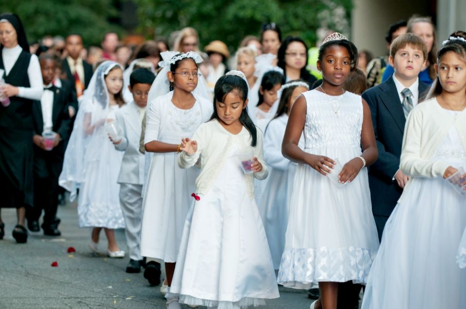 Children receiving first Communion scatter rose petals during a eucharistic procession through downtown Charlotte, North Carolina, in 2014. (CNS/Catholic News Herald/Bill Washington) Children receiving first Communion scatter rose petals during a eucharistic procession through downtown Charlotte, North Carolina, in 2014. (CNS/Catholic News Herald/Bill Washington)