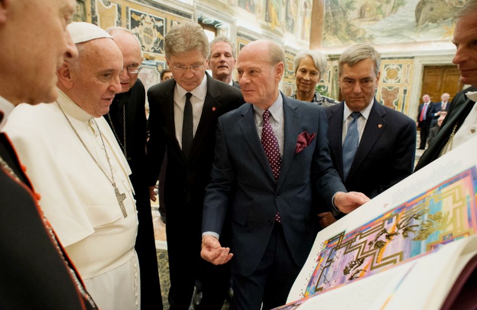 Pope Francis accepts the final volume of The St. John's Bible at the end of an audience with the Papal Foundation at the Vatican in April 2015. (CNS/L'Osservatore Romano)