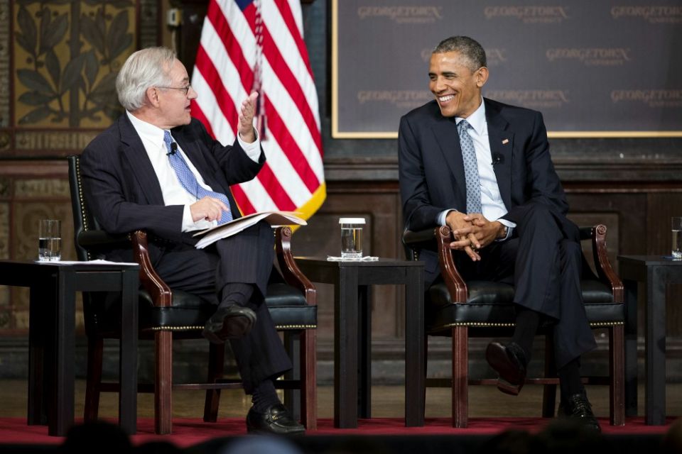 Then-President Barack Obama shares a light moment with E.J. Dionne Jr. May 12, 2015, during the Catholic-Evangelical Leadership Summit on Overcoming Poverty at Georgetown University in Washington. (CNS/Tyler Orsburn)