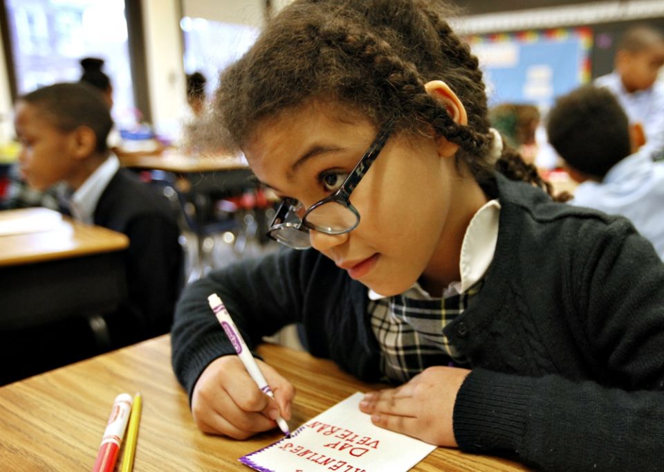Third-grade student Elaine Chatman-Borowiec makes a valentine to send to a veteran as part of a Catholic Schools Week activity at St. Thomas the Apostle School in Chicago Feb. 2, 2016. (CNS/Catholic New World/Karen Callaway)
