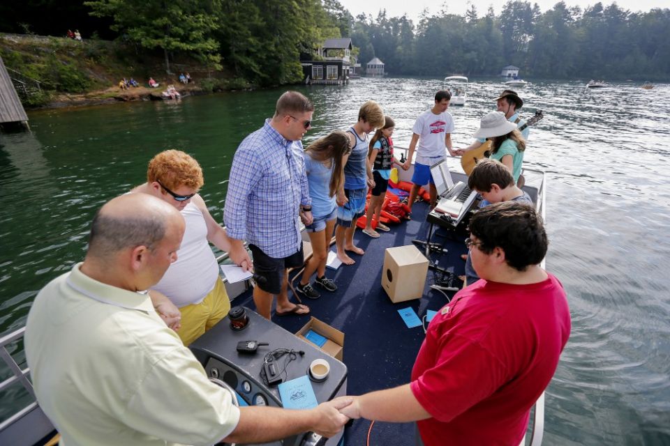 Members of the Clayton First United Methodist Church pray in 2015 during a service on a lake in Lakemont, Georgia. (CNS/Erik S. Lesser)