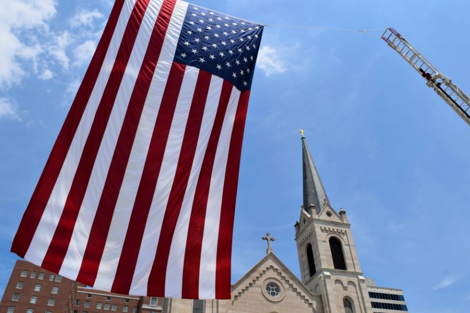 A 48-foot U.S. flag is seen June 24, 2016, outside Sacred Heart Church in downtown Peoria, Illinois. (CNS/Catholic Post/Tom Dermody)