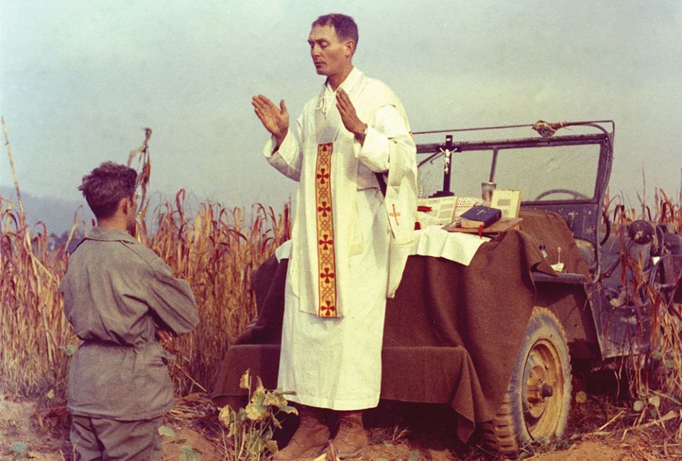 U.S. Army chaplain Father Emil Joseph Kapaun, who died May 23, 1951, in a North Korean prisoner-of-war camp, celebrates Mass from the hood of a jeep Oct. 7, 1950, in South Korea. (CNS/Courtesy of U.S. Army medic Raymond Skeehan) U.S. Army chaplain Father Emil Joseph Kapaun, who died May 23, 1951, in a North Korean prisoner-of-war camp, celebrates Mass from the hood of a jeep Oct. 7, 1950, in South Korea. (CNS/Courtesy of U.S. Army medic Raymond Skeehan)