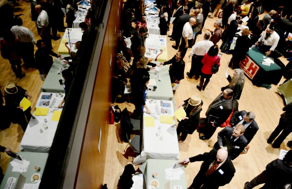 Jobseekers line up to meet with a prospective employer during a 2013 job fair in New York City. (CNS/EPA/Andrew Gombert)