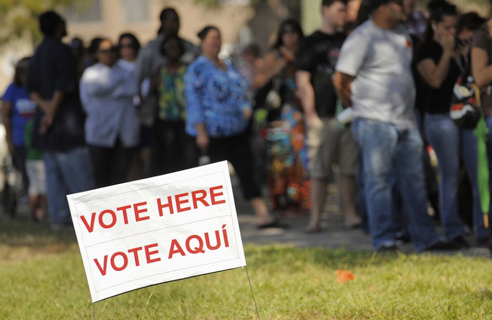 A sign in English and Spanish is seen as people wait to vote in 2012 outside a polling place in Kissimmee, Florida. (CNS/Reuters/Scott A. Miller) A sign in English and Spanish is seen as people wait to vote in 2012 outside a polling place in Kissimmee, Florida. (CNS/Reuters/Scott A. Miller)