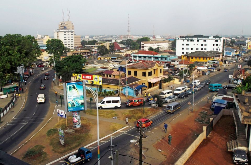 Cars and people travel through a business area in 2016 in Accra, Ghana. (CNS/Luc Gnago, Reuters)