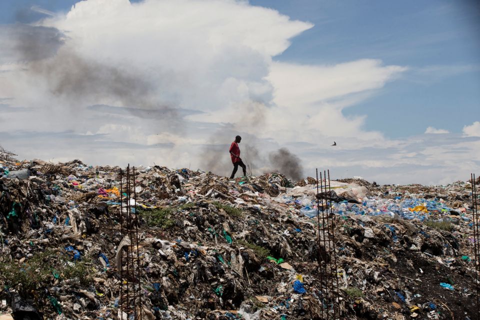 A man walks in a garbage dump in Kisumu, Kenya, April 18. (CNS/Baz Ratner, Reuters)