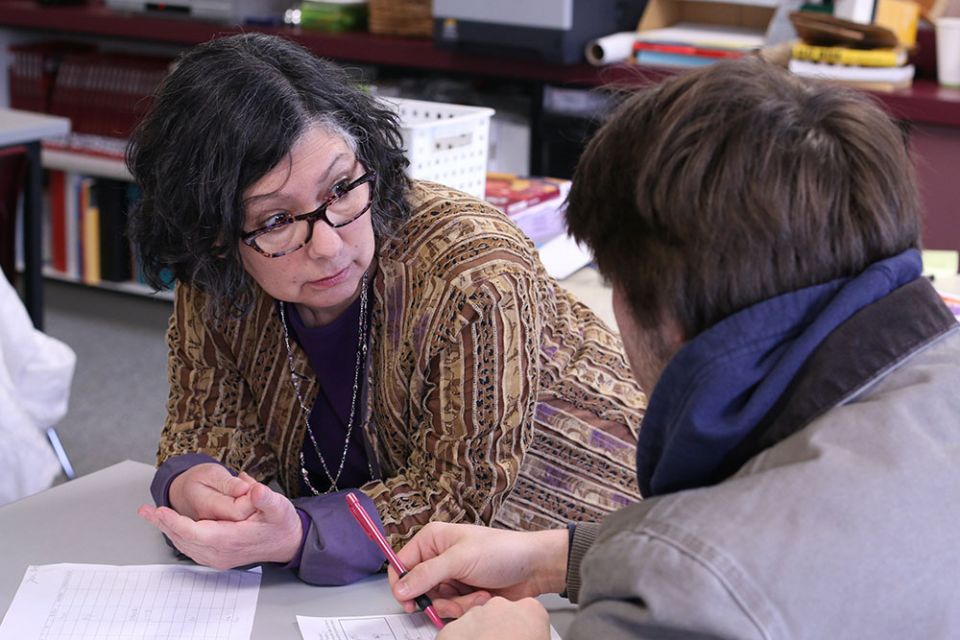Teacher Claudia Raffaele, an immigrant from Argentina, is seen with a student at Jesuit High School in Portland, Oregon, in 2017. (CNS/Catholic Sentinel/Katie Scott)