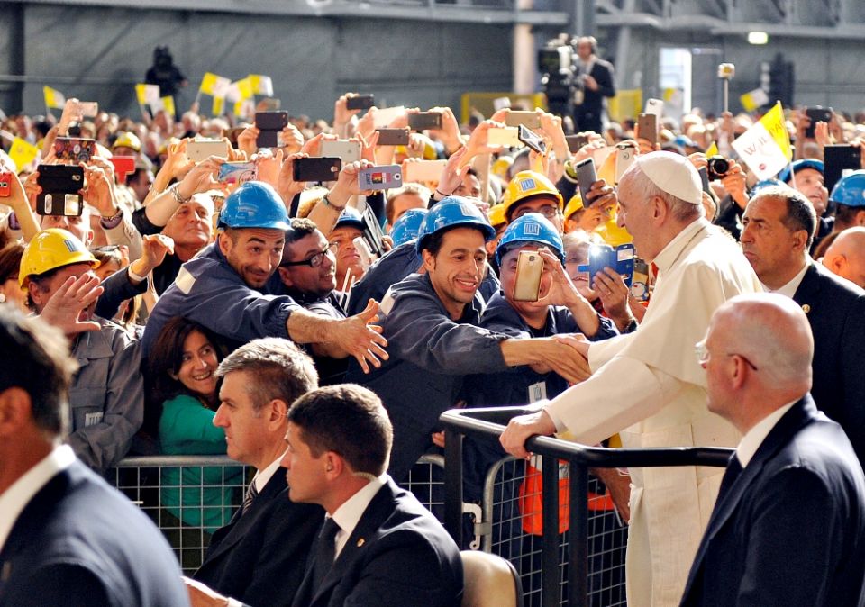 Pope Francis greets workers as he arrives at the ILVA steel plant during a May 2017 pastoral visit in Genoa, Italy. (CNS/Reuters/Giorgio Perottino)