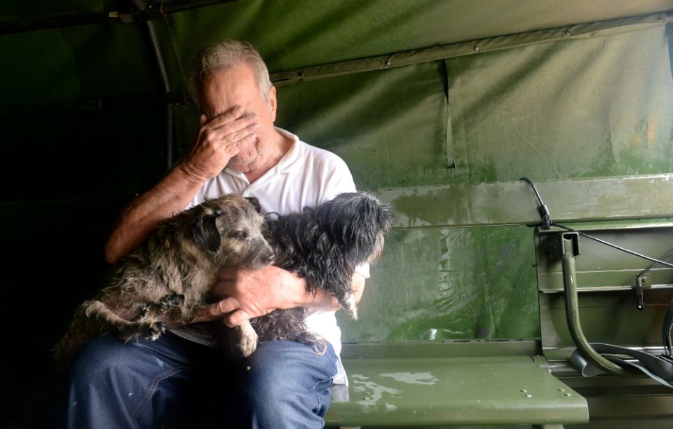 An evacuee holding two dogs becomes emotional after his Aug. 29 rescue by Texas National Guardsmen from severe flooding from Tropical Storm Harvey in Houston. (CNS/Army National Guard handout via Reuters/U.S. Army Capt. Martha Nigrelle) An evacuee holding two dogs becomes emotional after his Aug. 29 rescue by Texas National Guardsmen from severe flooding from Tropical Storm Harvey in Houston. (CNS/Army National Guard handout via Reuters/U.S. Army Capt. Martha Nigrelle)
