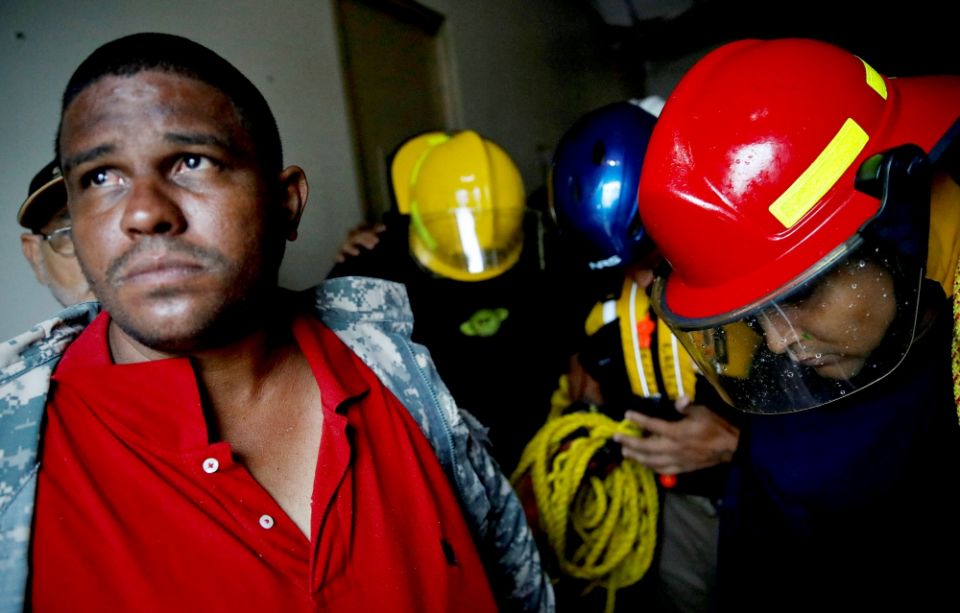 Rescue workers pray before walking out from the Emergency Operation Center in Guayama, Puerto Rico, after Hurricane Maria hit Sept. 20. (CNS/Reuters/Carlos Garcia Rawlins) Rescue workers pray before walking out from the Emergency Operation Center in Guayama, Puerto Rico, after Hurricane Maria hit Sept. 20. (CNS/Reuters/Carlos Garcia Rawlins)