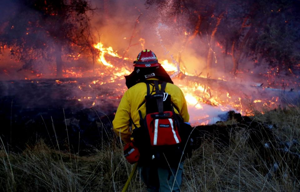 A firefighter battles a wildfire Oct. 14 near Santa Rosa, California. (CNS/Reuters/Jim Urquhart) A firefighter battles a wildfire Oct. 14 near Santa Rosa, California. (CNS/Reuters/Jim Urquhart)