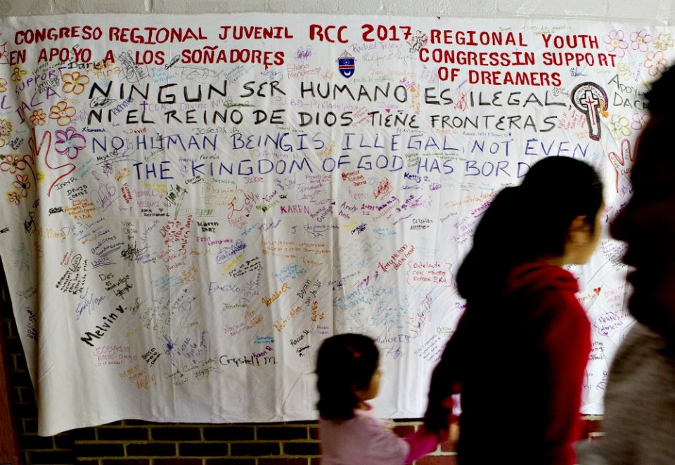 People walk in front of a banner supporting "Dreamers" during a daylong regional encuentro Oct. 28 at Herndon Middle School in Herndon, Virginia. (CNS/Tyler Orsburn) People walk in front of a banner supporting "Dreamers" during a daylong regional encuentro Oct. 28 at Herndon Middle School in Herndon, Virginia. (CNS/Tyler Orsburn)