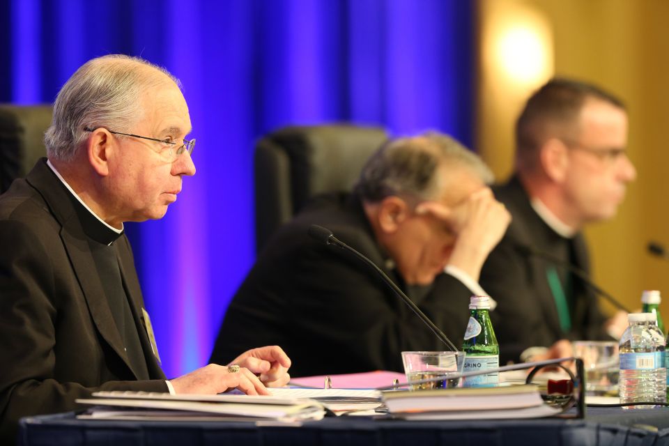 Archbishop Jose H. Gomez of Los Angeles, vice president of the U.S. Conference of Catholic Bishops, gives the opening prayer Nov. 13 at the bishops' fall general assembly in Baltimore. Also pictured are Cardinal Daniel N. DiNardo of Galveston-Houston, USC