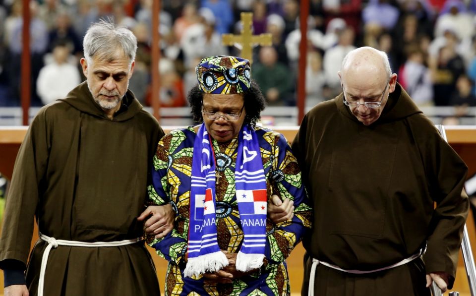 Paula Medina Zarate is escorted by two Franciscans as she carries a relic of Blessed Solanus Casey during his beatification Mass Nov. 18 at Ford Field in Detroit. (CNS/Courtesy of Michigan Catholic/Jeff Kowalsky) Paula Medina Zarate is escorted by two Franciscans as she carries a relic of Blessed Solanus Casey during his beatification Mass Nov. 18 at Ford Field in Detroit. (CNS/Courtesy of Michigan Catholic/Jeff Kowalsky)