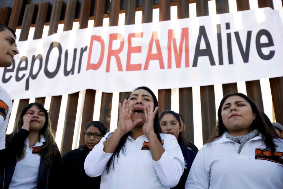Beneficiaries of the federal Deferred Action for Childhood Arrivals program attend the "Keep Our Dream Alive" binational meeting in 2017. They gathered at the U.S.-Mexico border wall in Sunland Park, New Mexico. (CNS/Reuters/Jose Luis Gonzalez)