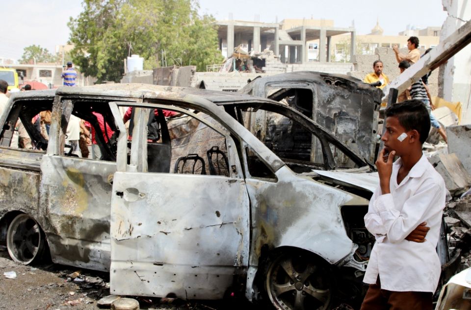 People inspect the damages after a car bombing March 13 in Aden, Yemen. (CNS/Reuters/Fawaz Salman)