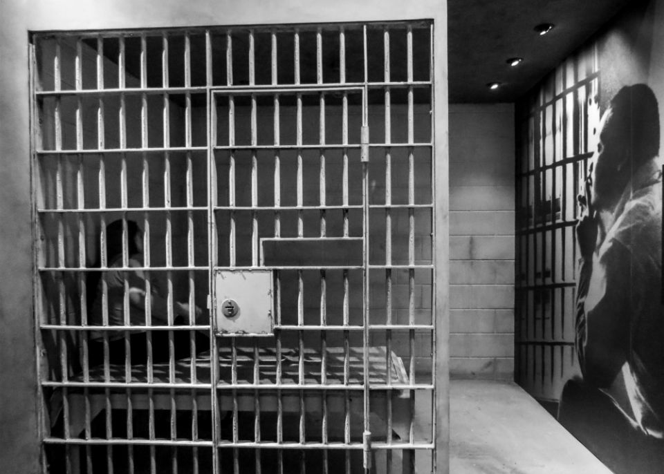 A visitor sits in a replica of a jail cell next to a portrait of the Rev. Martin Luther King Jr., in 2015 at the National Civil Rights Museum in Memphis, Tennessee. (CNS/EPA/Tannen Maury) A visitor sits in a replica of a jail cell next to a portrait of the Rev. Martin Luther King Jr., in 2015 at the National Civil Rights Museum in Memphis, Tennessee. (CNS/EPA/Tannen Maury)